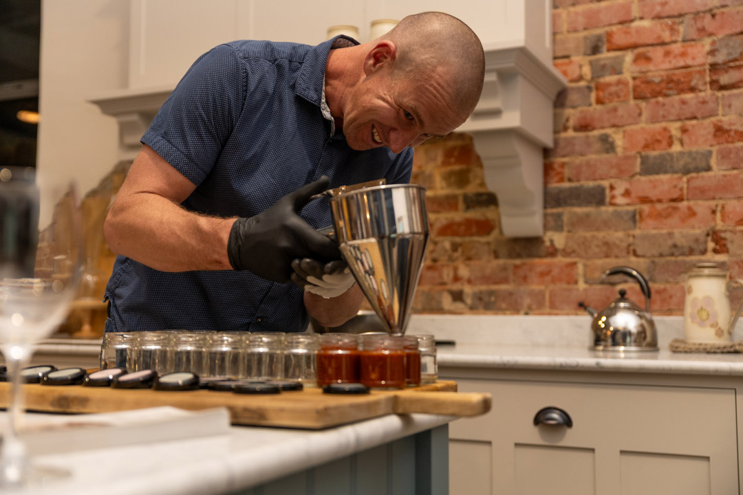 Chef filling jars with chutney in Saltwood kitchen